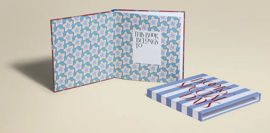 A Book of Special Days open beside a Heritage Red slipcase — a modern memory book designed to capture meaningful moments and last a lifetime